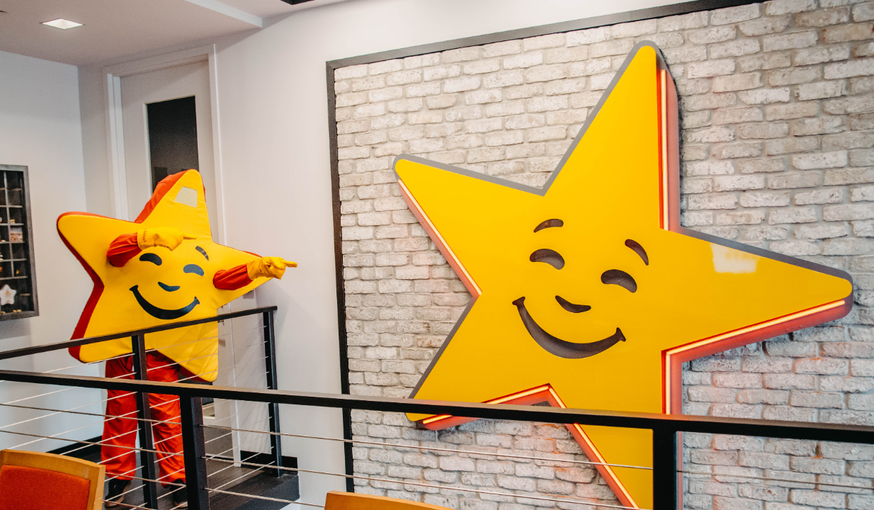 Shining Star mascot standing next to Shining Star sign